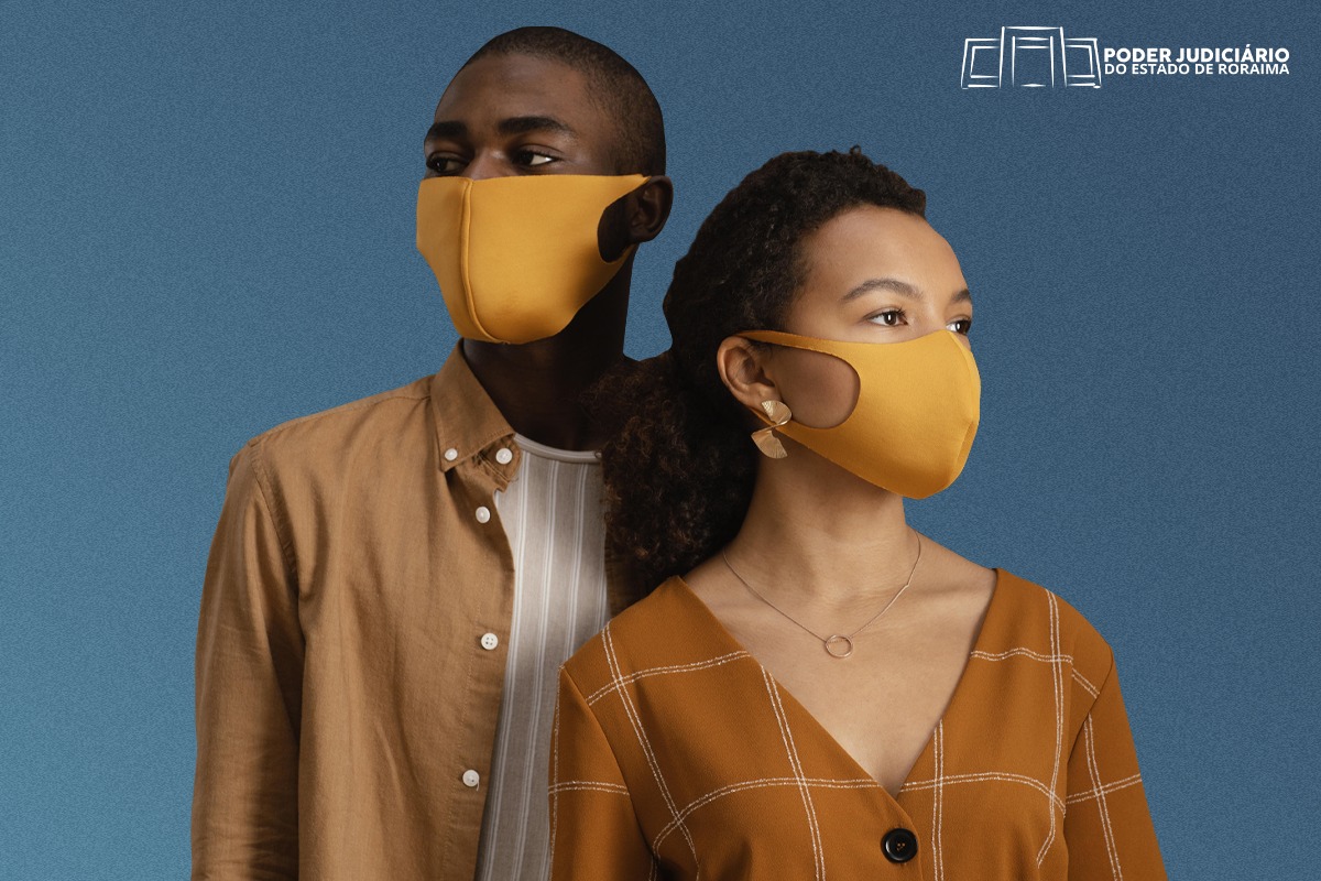 Um casal de jovens usando máscaras amarelas 