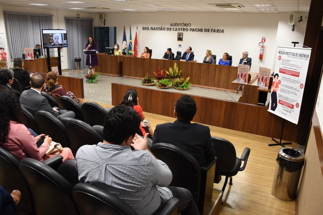 Imagem colorida mostra o auditório de desembargador  gastão de castro pache de farias, ocupados por servidores, servidoras, magistrados e magistradas do Poder Judiciário de roraima, à frente estar a mesa de autoridade ocupados por magistrados.