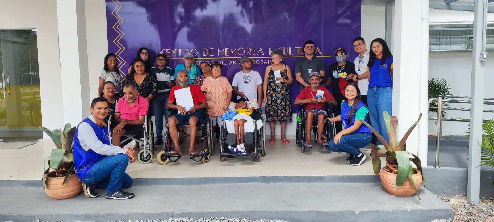 foto colorida de vários idosos pousando para foto em frente ao centro de memoria 