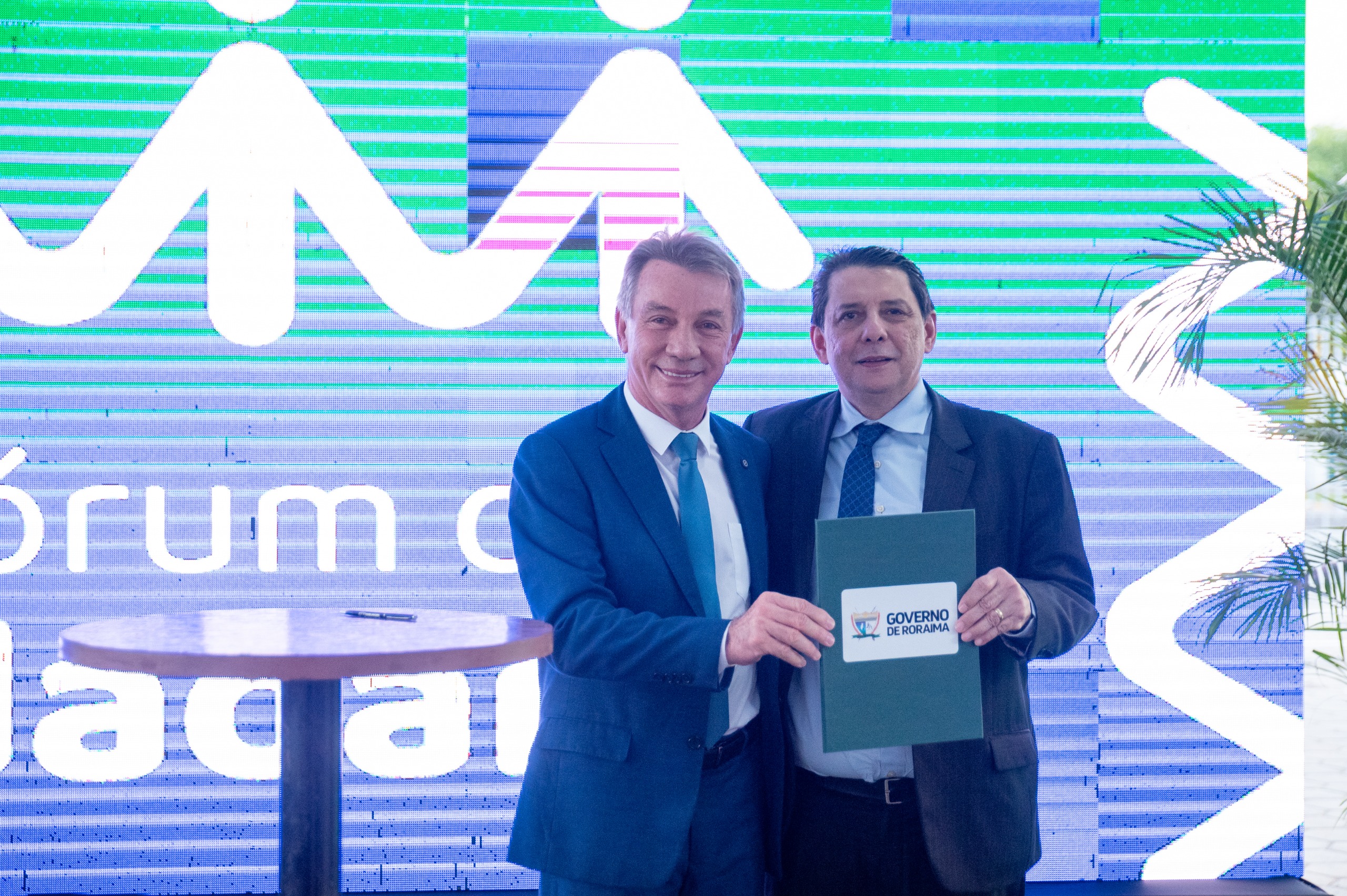  Imagem colorida contém o presidente do Tribunal de Justiça de Roraima (TJRR), desembargador Jésus Nascimento posando para fotografia ao lado do governador do Estado de Roraima, Antonio Denarium, enquanto seguram termo de adesão ao espaço no Fórum da Cidadania, durante inauguração que ocorreu no dia 12 de dezembro de 2024. 