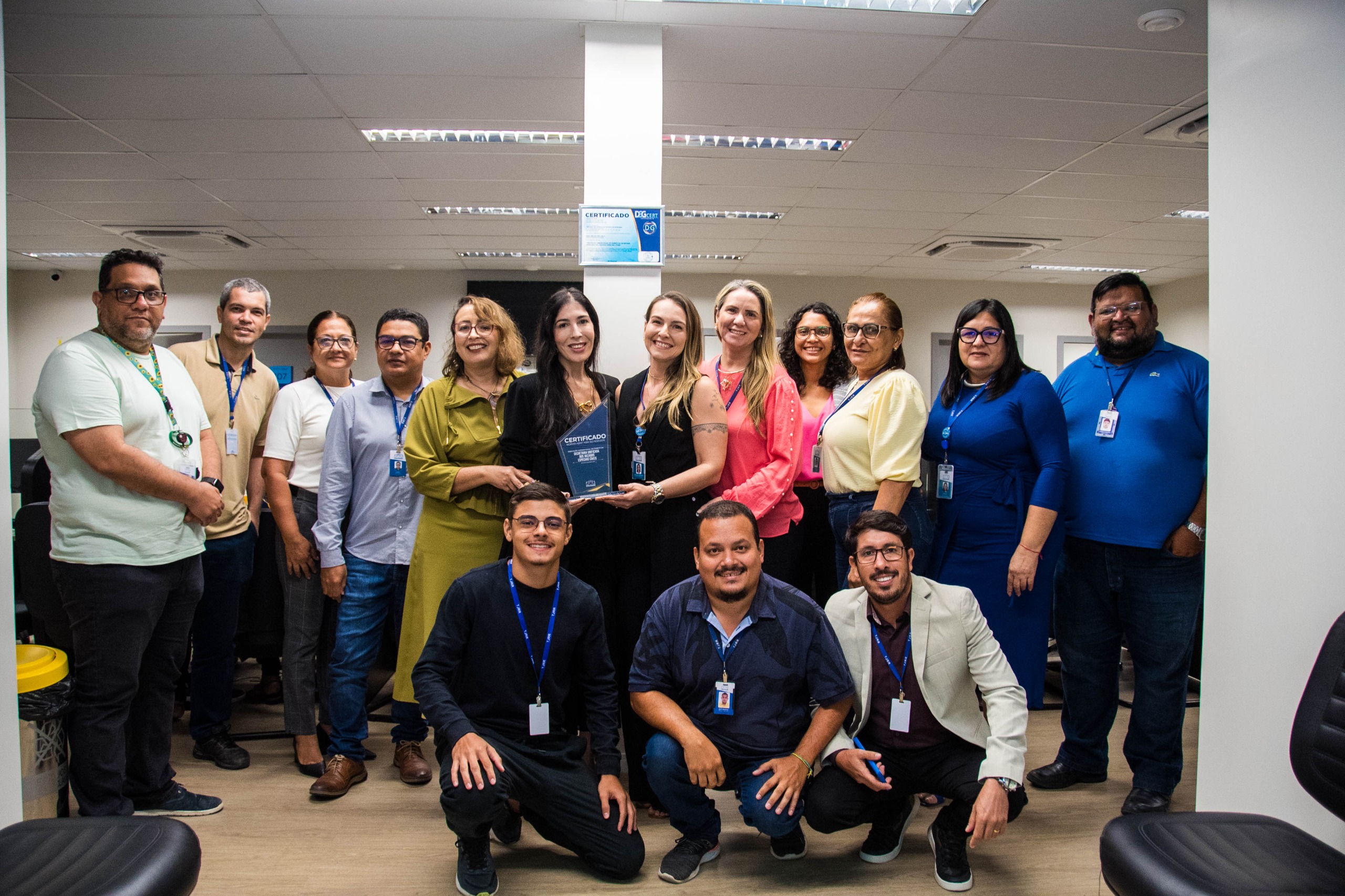 Imagem colorida contém a juíza Suelen Márcia Silva Alves, titular do 1.º Juizado Especializado de Violência Doméstica e Familiar contra a Mulher, segurando placa de premiação da certificação do ISO 9001, e posando para fotografia ao lado da Juíza Auxiliar da Presidência do TJRR, Lana Leitão, da Subsecretária de Processos e Gestão da Qualidade, Erika Horta e mais sete servidores do TJRR. Imagem colorida contém a juíza Suelen Márcia Silva Alves, titular do 1.º Juizado Especializado de Violência Doméstica e Familiar contra a Mulher, segurando placa de premiação da certificação do ISO 9001, e posando para fotografia ao lado da Juíza Auxiliar da Presidência do TJRR, Lana Leitão, da Subsecretária de Processos e Gestão da Qualidade, Erika Horta e mais sete servidores do TJRR.