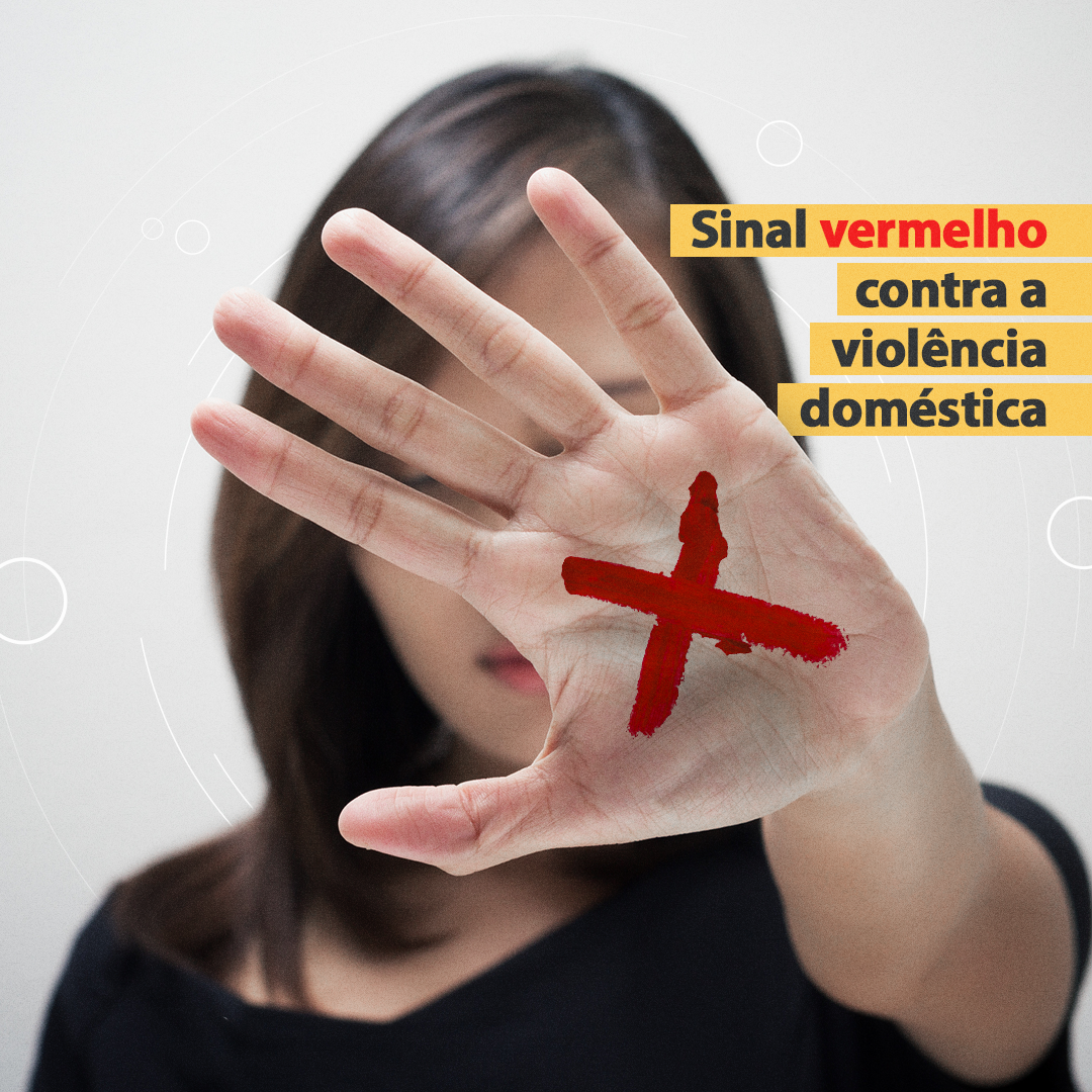 Baner da campanha: uma mulher com um dos braços esticados e um X vermelho desenhado na palma da mão. 